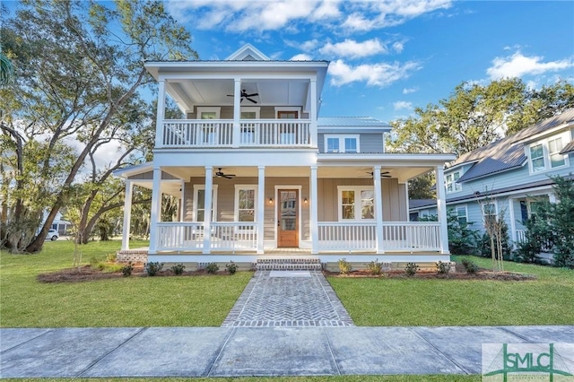 view of front of property with a front yard, ceiling fan, and a porch