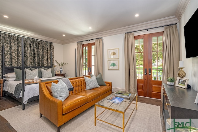 bedroom featuring access to outside, wood-type flooring, french doors, and ornamental molding