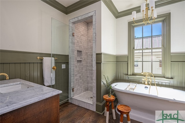 bathroom featuring shower with separate bathtub, crown molding, a chandelier, and vanity