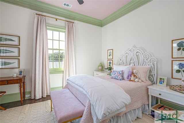 bedroom with hardwood / wood-style floors, ceiling fan, and crown molding