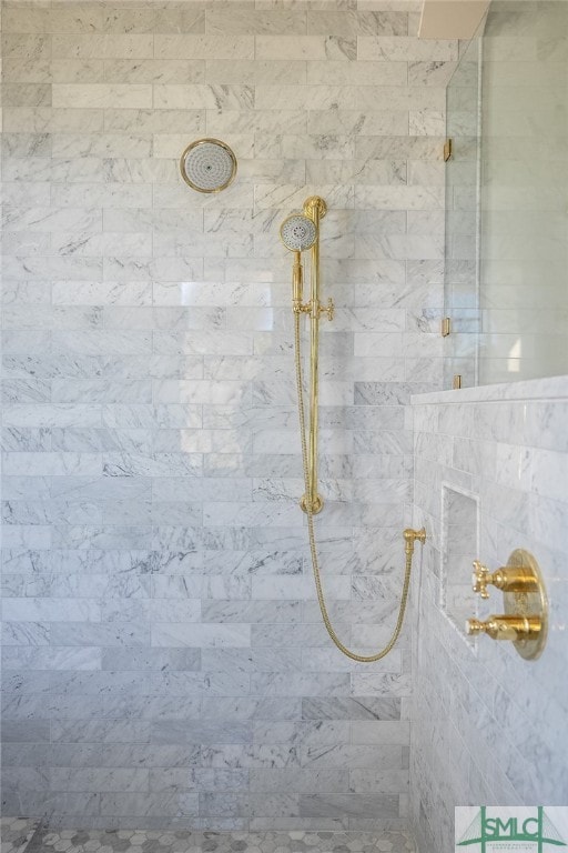 interior details featuring tiled shower