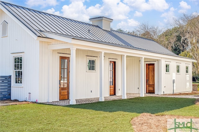 exterior space featuring a porch and a yard