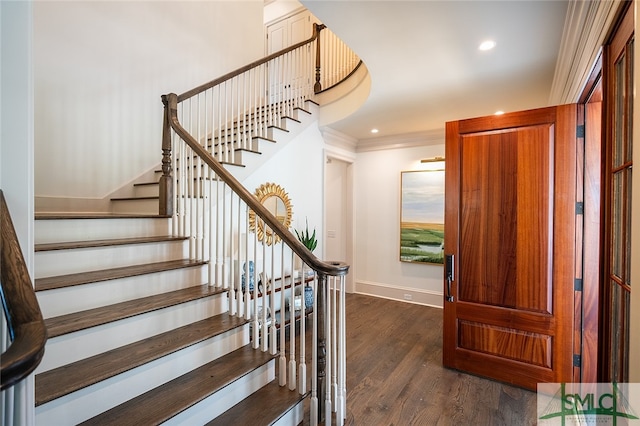 entryway featuring dark wood-type flooring and ornamental molding