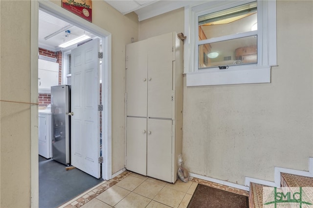 116 E 66th St, Savannah, GA 31405 - corridor with washer / clothes dryer and light tile floors