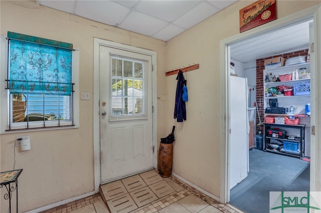 116 E 66th St, Savannah, GA 31405 - entryway featuring a drop ceiling, brick wall, and light tile floors