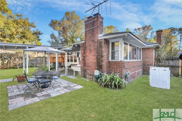 116 E 66th St, Savannah, GA 31405 - back of property featuring a patio area and a lawn