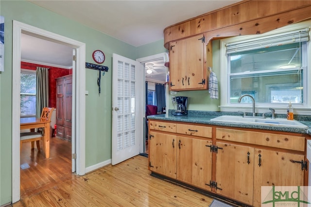116 E 66th St, Savannah, GA 31405 - kitchen featuring light hardwood / wood-style flooring and sink
