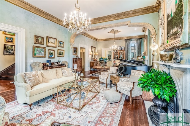 living room featuring a notable chandelier, ornamental molding, and hardwood / wood-style floors