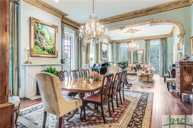 dining room featuring crown molding, hardwood / wood-style flooring, and a chandelier