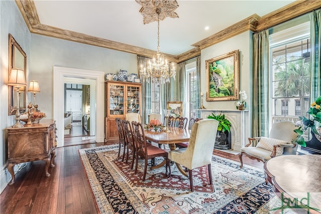 dining space featuring an inviting chandelier, dark hardwood / wood-style floors, and crown molding