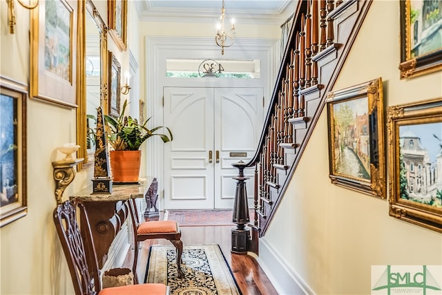 entrance foyer with hardwood / wood-style floors and ornamental molding