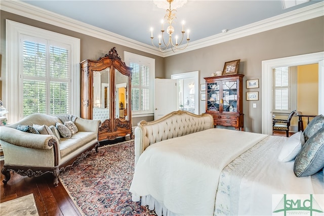 bedroom with crown molding, wood-type flooring, and an inviting chandelier