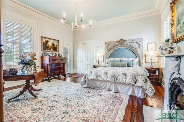 bedroom featuring a chandelier, hardwood / wood-style floors, crown molding, and multiple windows