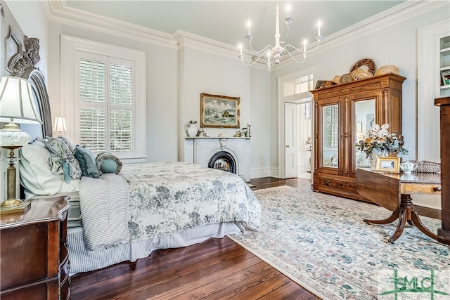 bedroom with a chandelier, crown molding, and hardwood / wood-style floors