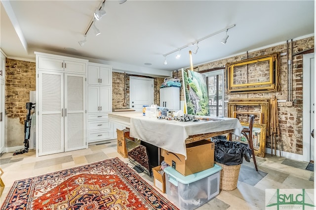 interior space featuring track lighting and light tile floors