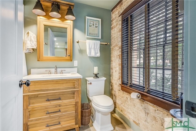 bathroom featuring tile floors, toilet, and vanity