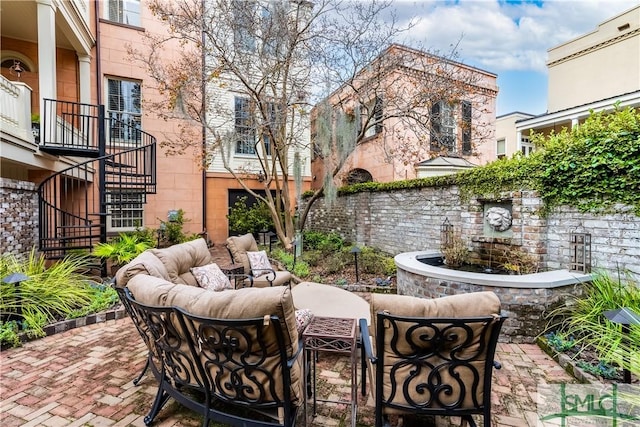 view of patio featuring stairway and an outdoor living space