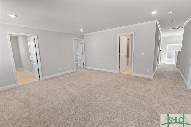 unfurnished bedroom featuring light carpet, visible vents, connected bathroom, and ornamental molding