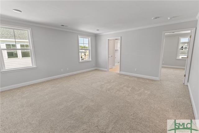 unfurnished room with light carpet, ornamental molding, visible vents, and baseboards