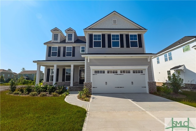 view of front of house with a porch, a garage, and a front lawn