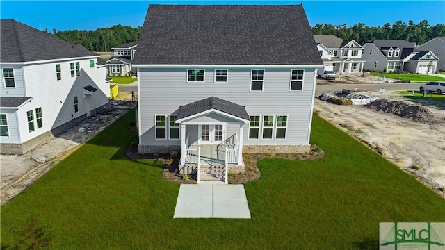 view of front of house featuring a front lawn, a shingled roof, and a residential view