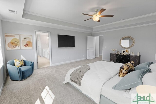 bedroom with carpet, visible vents, ornamental molding, and a raised ceiling