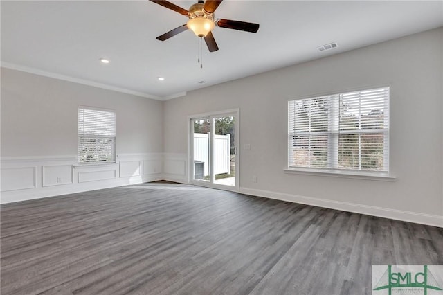 empty room featuring hardwood / wood-style flooring, a healthy amount of sunlight, and ceiling fan