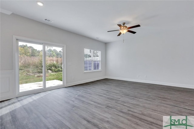 spare room with hardwood / wood-style flooring and ceiling fan