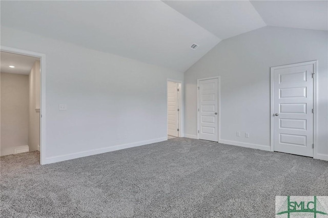 unfurnished bedroom featuring vaulted ceiling and carpet flooring