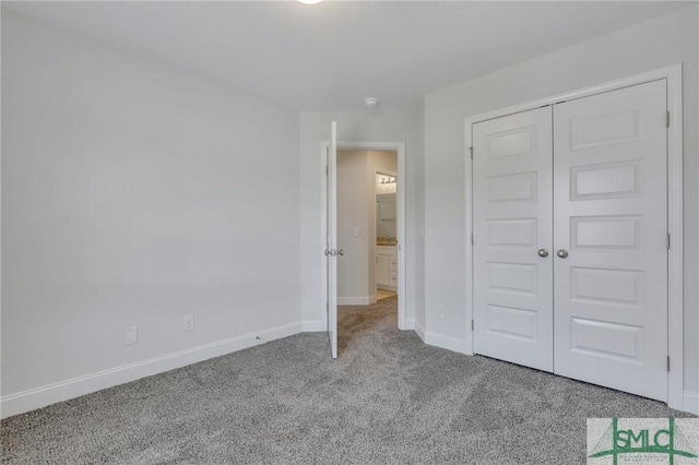 unfurnished bedroom featuring light colored carpet and a closet