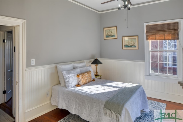 bedroom featuring ceiling fan, crown molding, and dark hardwood / wood-style floors