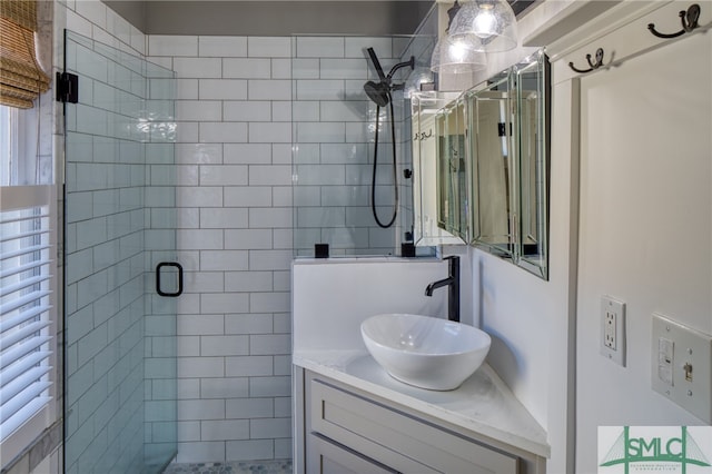 bathroom featuring large vanity and an enclosed shower