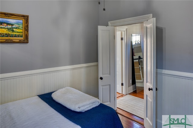 bedroom with dark hardwood / wood-style floors