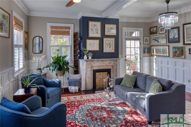 living room featuring dark hardwood / wood-style flooring, crown molding, and a premium fireplace