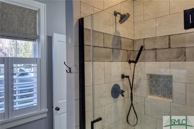 bathroom featuring a shower with door