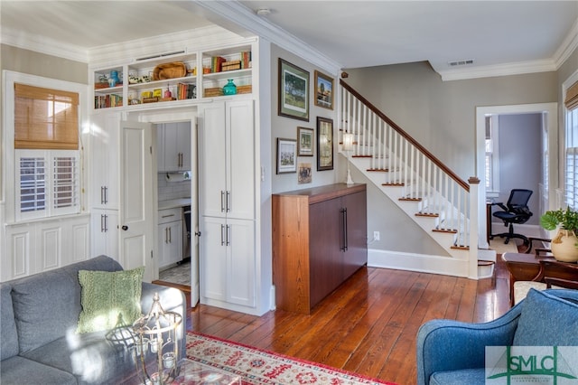 living room featuring dark hardwood / wood-style floors and ornamental molding