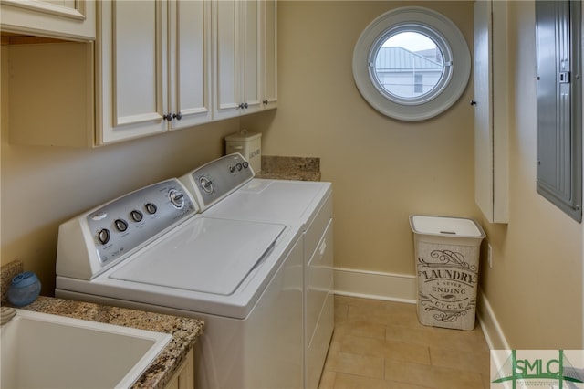 laundry area with light tile floors, cabinets, and separate washer and dryer