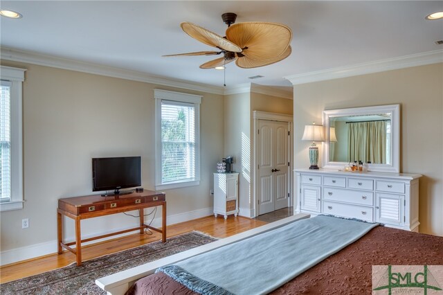 bedroom with light hardwood / wood-style floors, ceiling fan, and ornamental molding