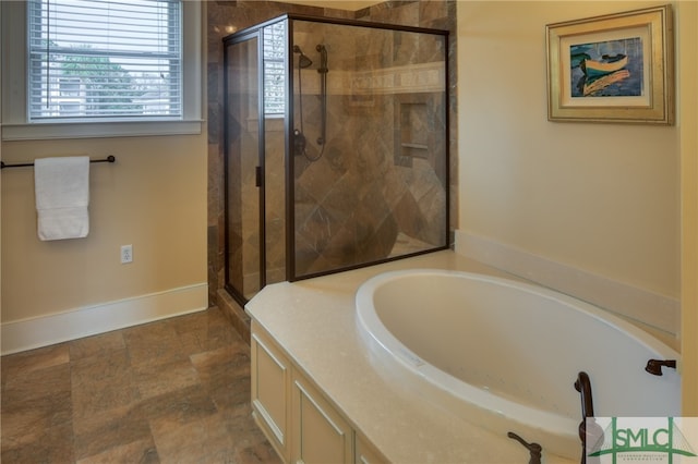 bathroom featuring tile flooring and separate shower and tub