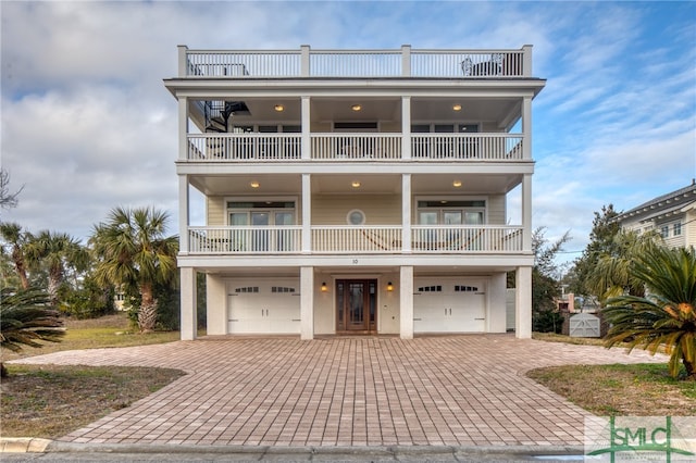 raised beach house with a balcony and a garage