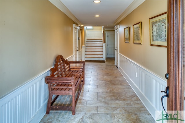 hall featuring light tile floors and ornamental molding