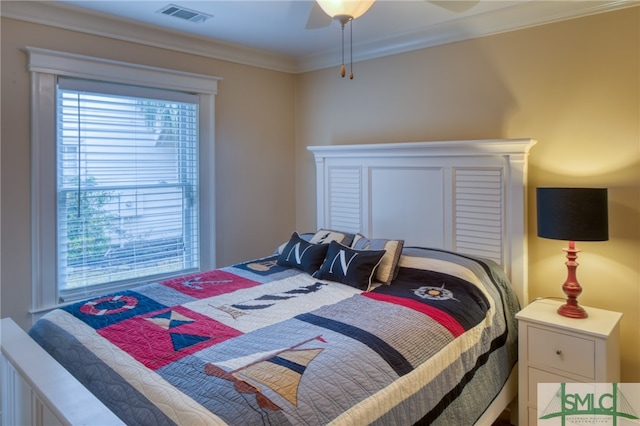 bedroom featuring crown molding, ceiling fan, and multiple windows