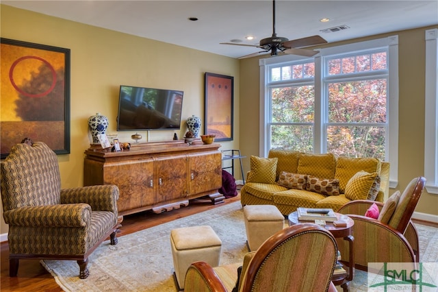 living room featuring ceiling fan and hardwood / wood-style flooring