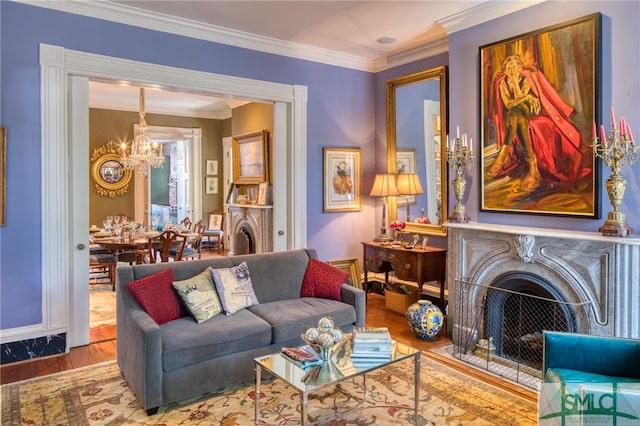 living room featuring washer / dryer, a chandelier, crown molding, and light hardwood / wood-style flooring