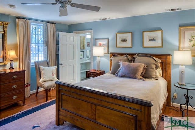 bedroom with ceiling fan and dark wood-type flooring