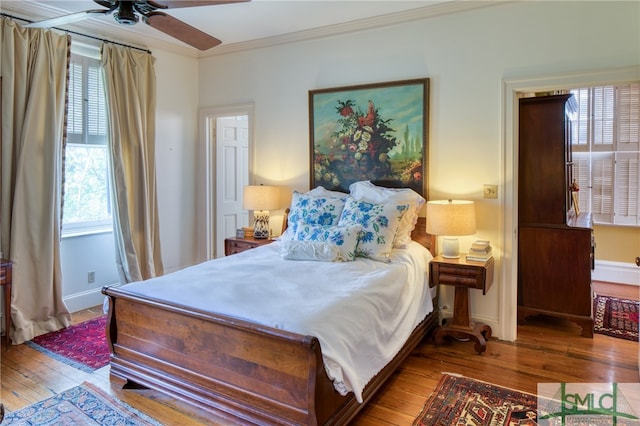 bedroom with crown molding, ceiling fan, and light hardwood / wood-style flooring