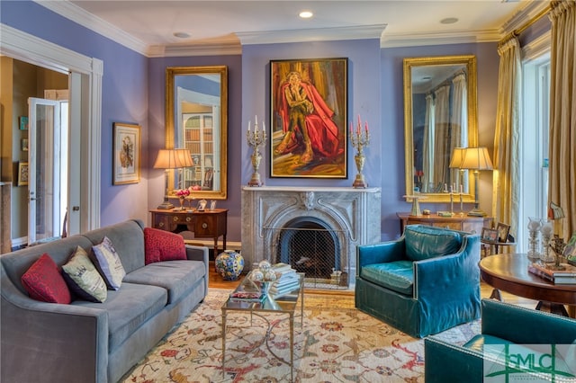 living room with a high end fireplace, light wood-type flooring, crown molding, and plenty of natural light