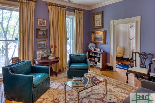 sitting room featuring light hardwood / wood-style flooring and ornamental molding