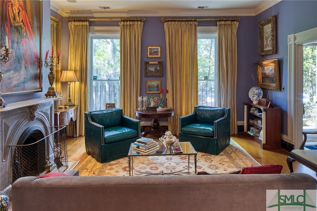 living room featuring crown molding and light hardwood / wood-style floors