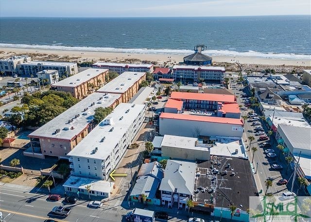 birds eye view of property featuring a view of the beach and a water view